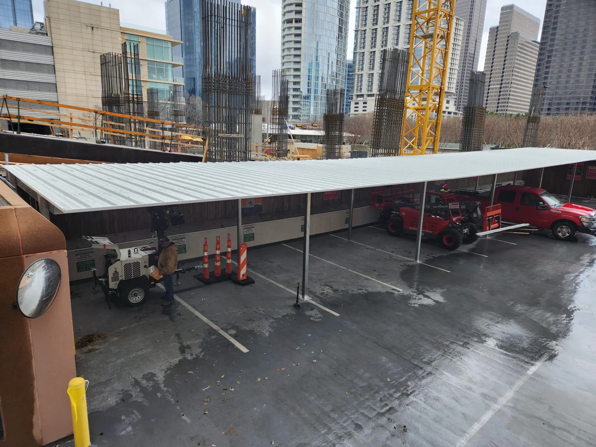 Steel carport canopy with parked vehicles